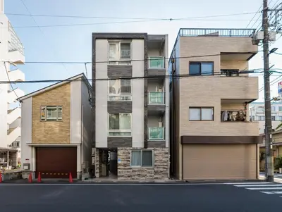an apartment building on the corner of a street at nestay inn tokyo ryogoku in Tokyo