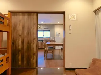 a kitchen and dining room with a sliding door at Hotel Futaba Heights -\u30d5\u30bf\u30d0\u30cf\u30a4\u30c4- in Tokyo