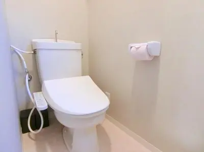 a bathroom with a toilet with a roll of toilet paper at Hotel Futaba Heights -\u30d5\u30bf\u30d0\u30cf\u30a4\u30c4- in Tokyo