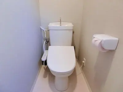 a bathroom with a toilet with a remote control at Hotel Futaba Heights -\u30d5\u30bf\u30d0\u30cf\u30a4\u30c4- in Tokyo