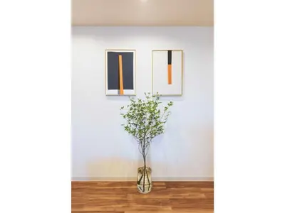 a vase with a plant in a room with three pictures at Tora Hotel Skytree - Vacation STAY 51801v in Tokyo