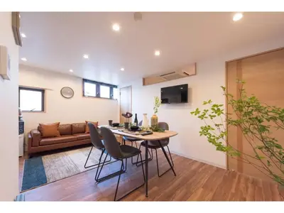 a living room with a table and chairs and a couch at Tora Hotel Skytree - Vacation STAY 51801v in Tokyo