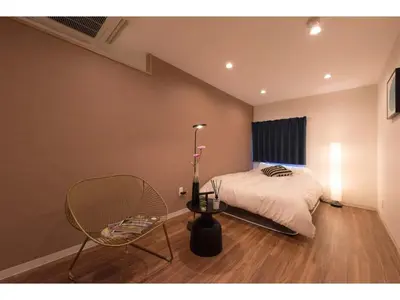 a bedroom with a bed and a chair and a lamp at Tora Hotel Skytree - Vacation STAY 51801v in Tokyo