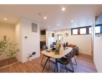 a dining room and living room with a table and chairs at Tora Hotel Skytree - Vacation STAY 51801v in Tokyo