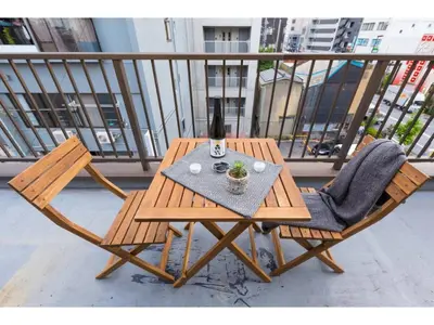 a wooden table with two chairs and a bottle of wine at Tora Hotel Skytree - Vacation STAY 51807v in Tokyo