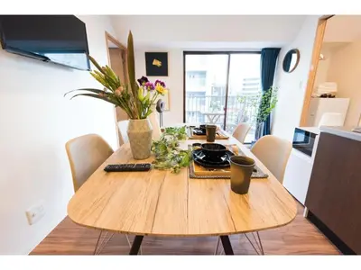a wooden table with flowers on it in a room at Tora Hotel Skytree - Vacation STAY 51807v in Tokyo