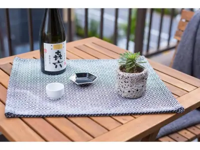 a bottle of wine sitting on a table with a plant at Tora Hotel Skytree - Vacation STAY 51807v in Tokyo