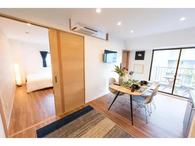 a living room with a table and a bedroom at Tora Hotel Skytree - Vacation STAY 51807v in Tokyo