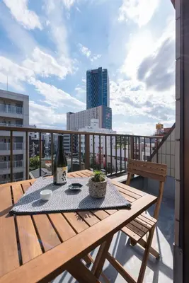 a wooden table on a balcony with a bottle of wine at Tora Hotel Skytree - Vacation STAY 51807v in Tokyo