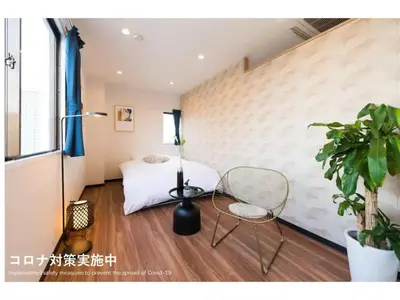 a bedroom with a bed and a chair and a plant at Tora Hotel Skytree - Vacation STAY 51816v in Tokyo