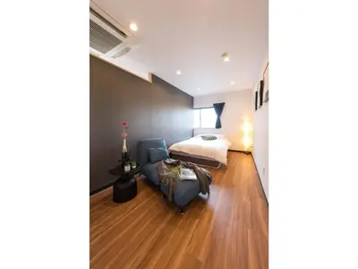 a bedroom with a bed and a couch and a chair at Tora Hotel Skytree - Vacation STAY 51816v in Tokyo