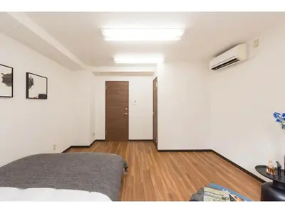 a living room with a bed and a hallway at Tora Hotel Rikugien - Vacation STAY 52738v in Tokyo