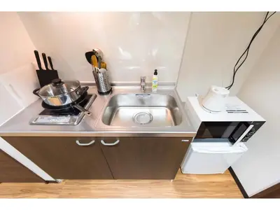 a small kitchen with a sink and a counter at Tora Hotel Rikugien - Vacation STAY 52738v in Tokyo