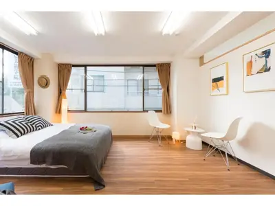 a bedroom with a large bed and two chairs at Tora Hotel Rikugien - Vacation STAY 52738v in Tokyo