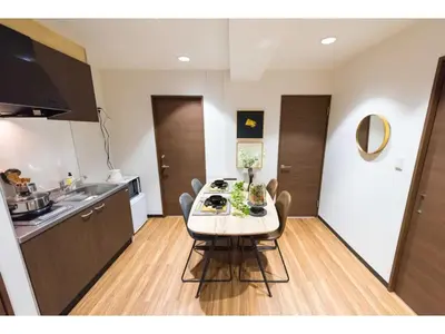 a kitchen with a table and chairs in a room at Tora Hotel Rikugien - Vacation STAY 52738v in Tokyo