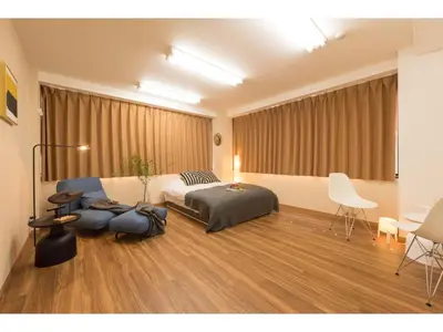 a bedroom with a bed and a table and chairs at Tora Hotel Rikugien - Vacation STAY 52738v in Tokyo