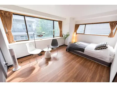 a bedroom with a bed and a table and chairs at Tora Hotel Rikugien - Vacation STAY 52741v in Tokyo