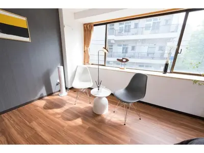 two chairs and a table in a room with a window at Tora Hotel Rikugien - Vacation STAY 52741v in Tokyo