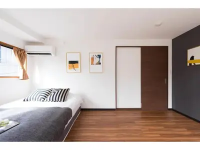 a bedroom with a bed and a sliding glass door at Tora Hotel Rikugien - Vacation STAY 52741v in Tokyo