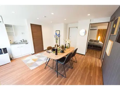 a dining room table and chairs in a living room at Tora Hotel Rikugien - Vacation STAY 52741v in Tokyo
