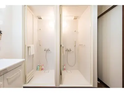 a white bathroom with a shower and a toilet at Tora Hotel Rikugien - Vacation STAY 52741v in Tokyo