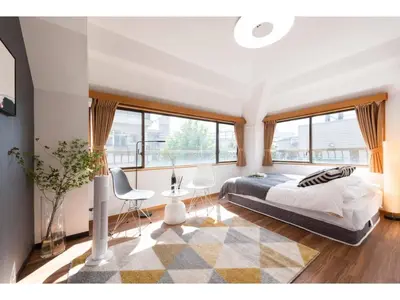 a bedroom with a bed and a large window at Tora Hotel Rikugien - Vacation STAY 52744v in Tokyo