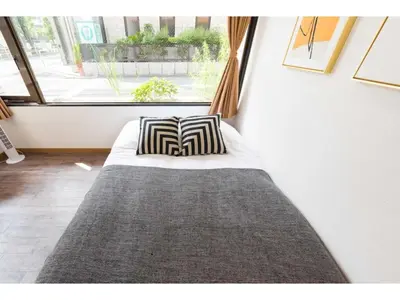 a bed with two pillows in a room with a window at Tora Hotel Rikugien - Vacation STAY 52726v in Tokyo