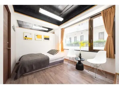 a bedroom with a bed and a large window at Tora Hotel Rikugien - Vacation STAY 52726v in Tokyo
