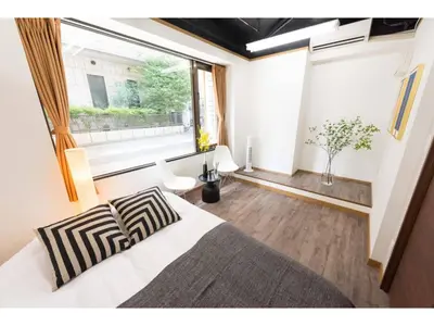 a bedroom with a bed and a large window at Tora Hotel Rikugien - Vacation STAY 52726v in Tokyo