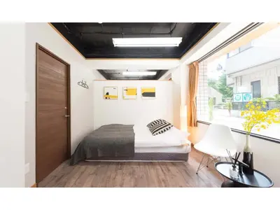 a bedroom with a bed and a large window at Tora Hotel Rikugien - Vacation STAY 52726v in Tokyo
