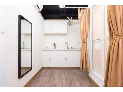 a bathroom with a mirror and a sink at Tora Hotel Rikugien - Vacation STAY 52726v in Tokyo