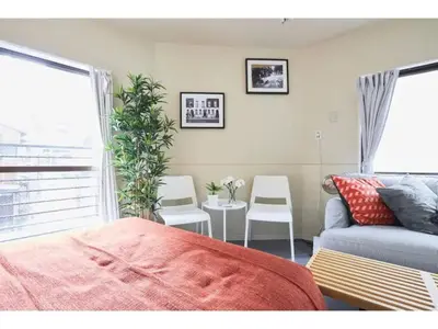a bedroom with a couch and a table and chairs at Tora Hotel Kitaueno - Vacation STAY 52747v in Tokyo