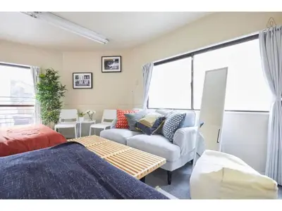 a living room with a bed and a couch at Tora Hotel Kitaueno - Vacation STAY 52747v in Tokyo