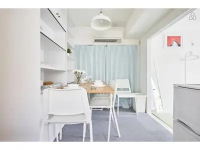 a dining room with a table and white chairs at Tora Hotel Kitaueno - Vacation STAY 52747v in Tokyo