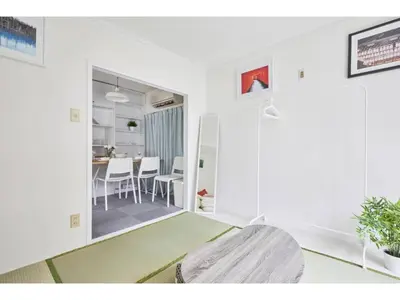 a white living room with a table and chairs at Tora Hotel Kitaueno - Vacation STAY 52747v in Tokyo
