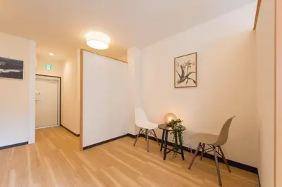 a room with a table and chairs and a white wall at Tora Hotel Ueno - Vacation STAY 52809v in Tokyo