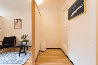 a living room with a chair and a table at Tora Hotel Ueno - Vacation STAY 52809v in Tokyo