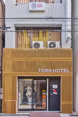 a store front of a building with a dog in the window at Tora Hotel Ueno - Vacation STAY 52806v in Tokyo