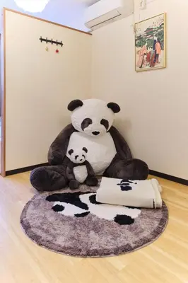 a large stuffed panda bear sitting on a floor at Tora Hotel Ueno - Vacation STAY 52806v in Tokyo
