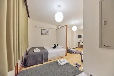 a bedroom with two beds and a mirror at Tora Hotel Ueno - Vacation STAY 52806v in Tokyo