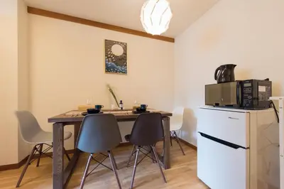 a kitchen with a table with chairs and a microwave at Tora Hotel Ueno - Vacation STAY 52811v in Tokyo