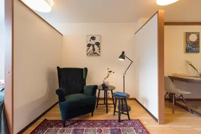 a living room with a green chair and a table at Tora Hotel Ueno - Vacation STAY 52811v in Tokyo