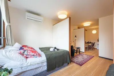 a bedroom with a bed and a living room at Tora Hotel Ueno - Vacation STAY 52811v in Tokyo