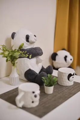 a stuffed panda bear sitting on a table with cups at Tora Hotel Ueno - Vacation STAY 52751v in Tokyo