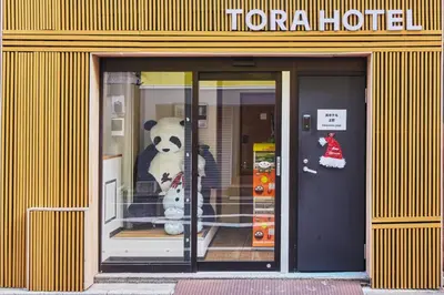 a store front with a stuffed panda bear in the door at Tora Hotel Ueno - Vacation STAY 52751v in Tokyo