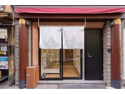 a store front with a window with a red awning at Tora Hotel Ueno - Vacation STAY 52751v in Tokyo