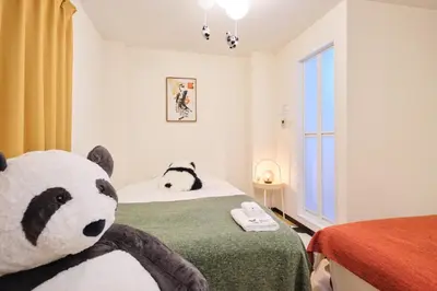 a bedroom with a bed with a panda bear on it at Tora Hotel Ueno - Vacation STAY 52751v in Tokyo