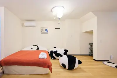 a bedroom with two stuffed pandas sitting on the floor at Tora Hotel Ueno - Vacation STAY 52751v in Tokyo