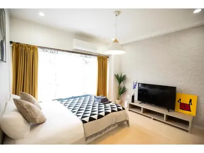 a bedroom with a large bed and a television at Tora Hotel Taito - Vacation STAY 53059v in Tokyo
