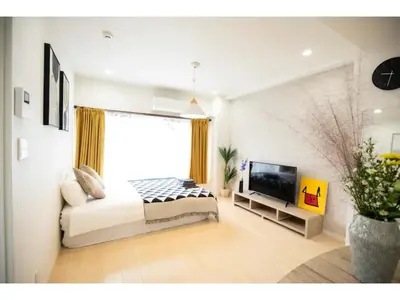 a bedroom with a large bed and a television at Tora Hotel Taito - Vacation STAY 53059v in Tokyo